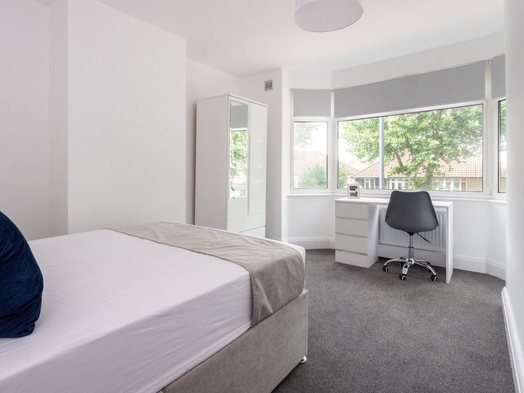 This inviting double bedroom features a comfort...
