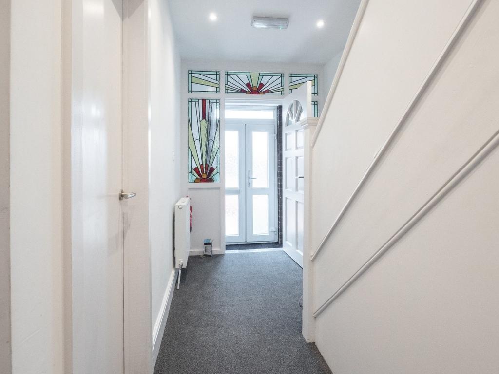A bright and welcoming hallway featuring modern...