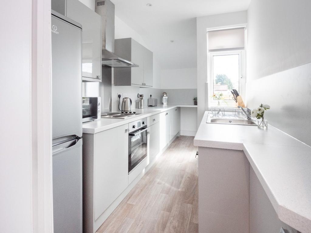 This modern kitchen features sleek cabinetry an...