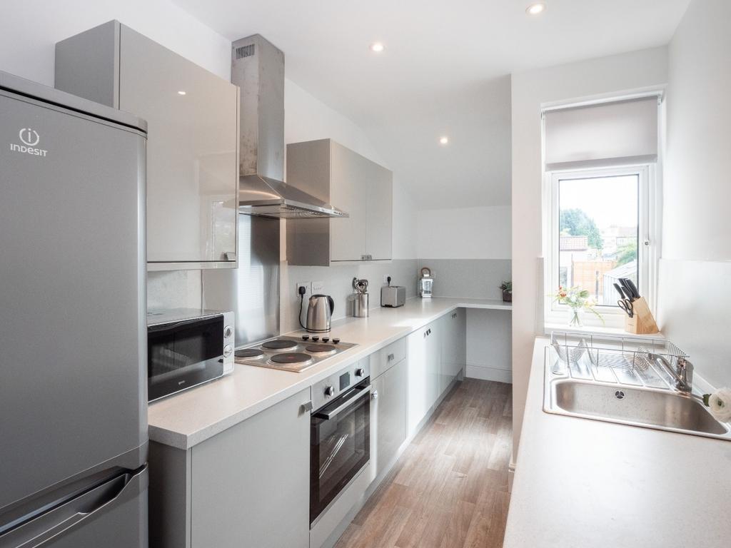 Modern kitchen featuring sleek cabinetry, ample...
