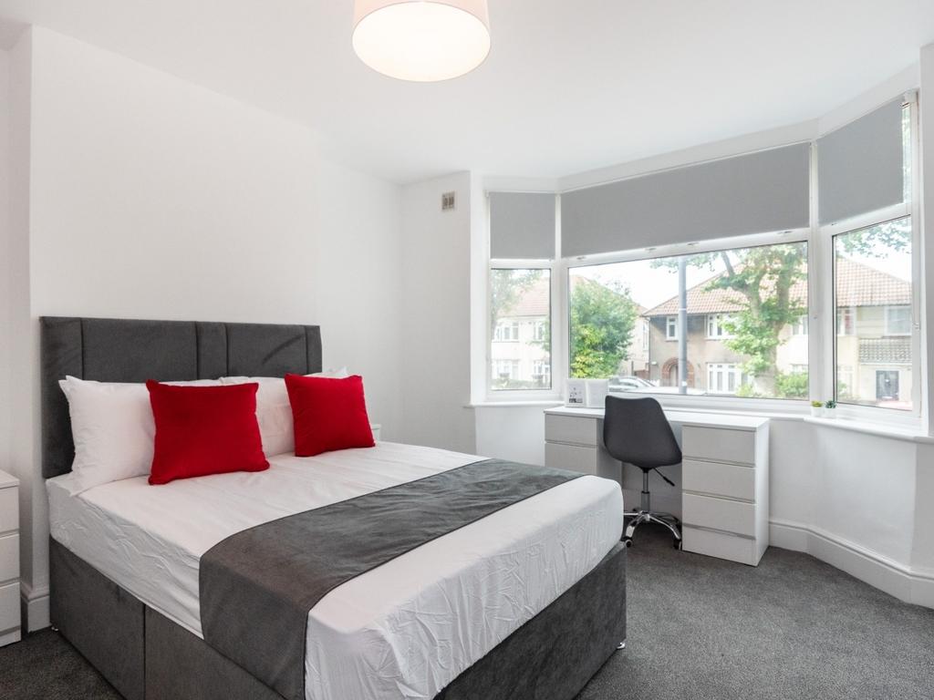 Bright and spacious double bedroom featuring a ...
