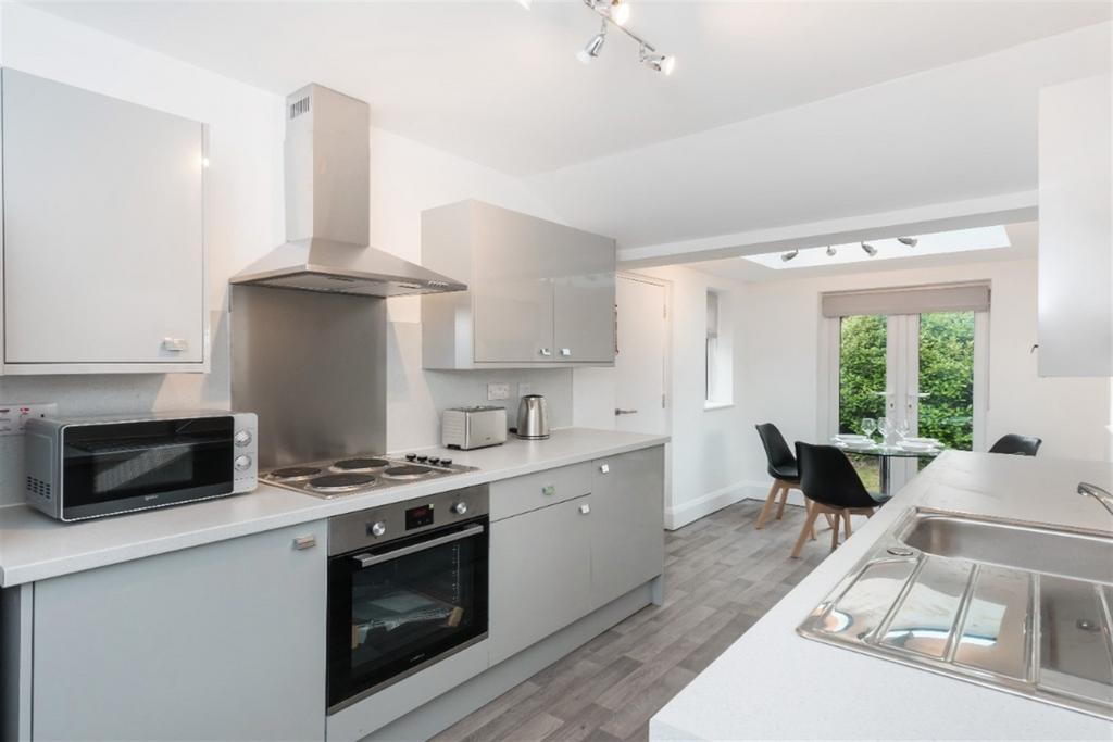 Bright and modern kitchen featuring sleek grey ...