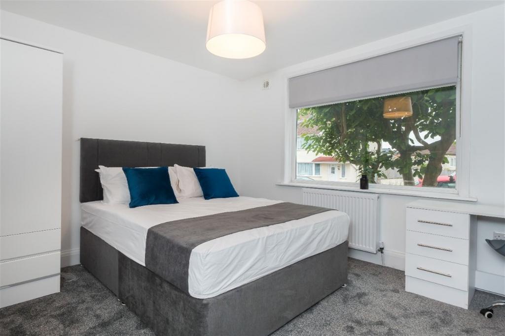 A bright and tidy double bedroom featuring a co...