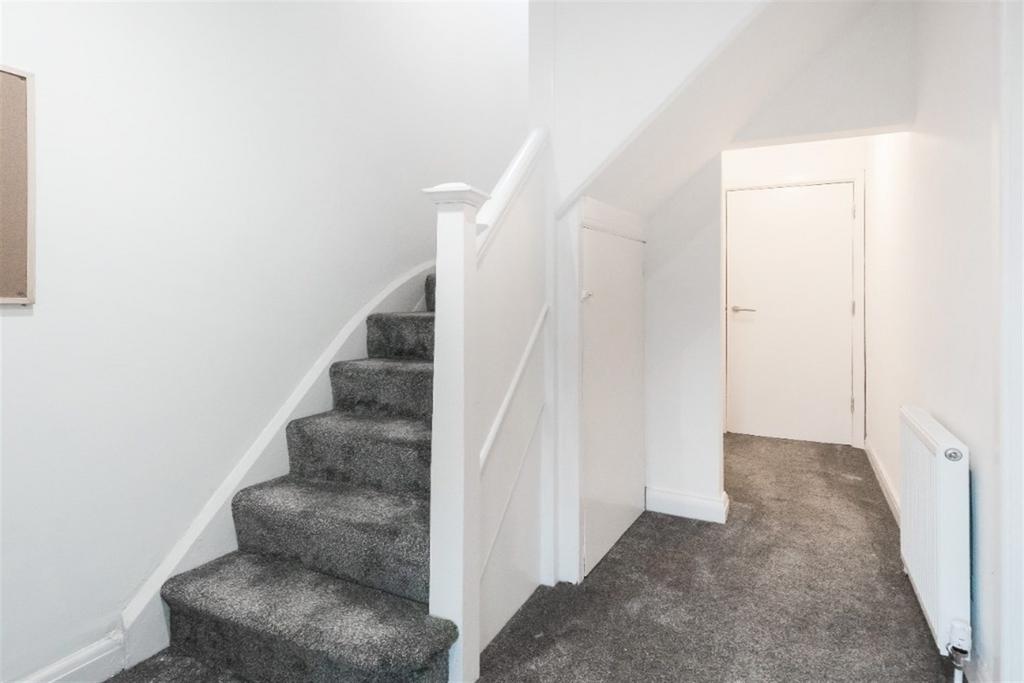 Bright, clean hallway with soft grey carpeting ...