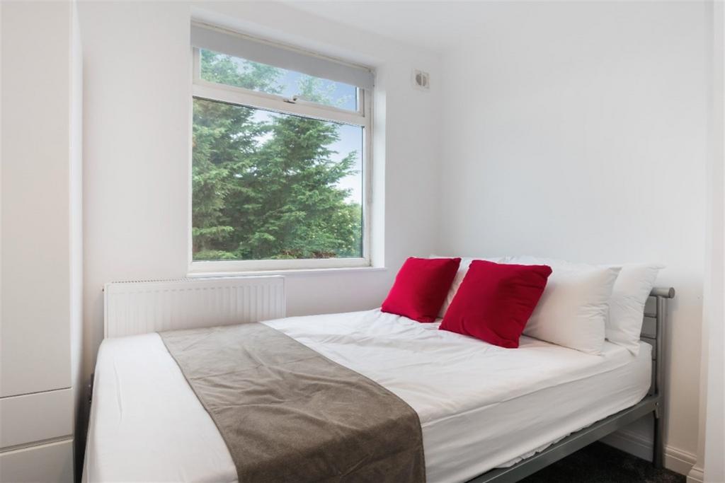 Bright and cozy double bedroom featuring a comf...