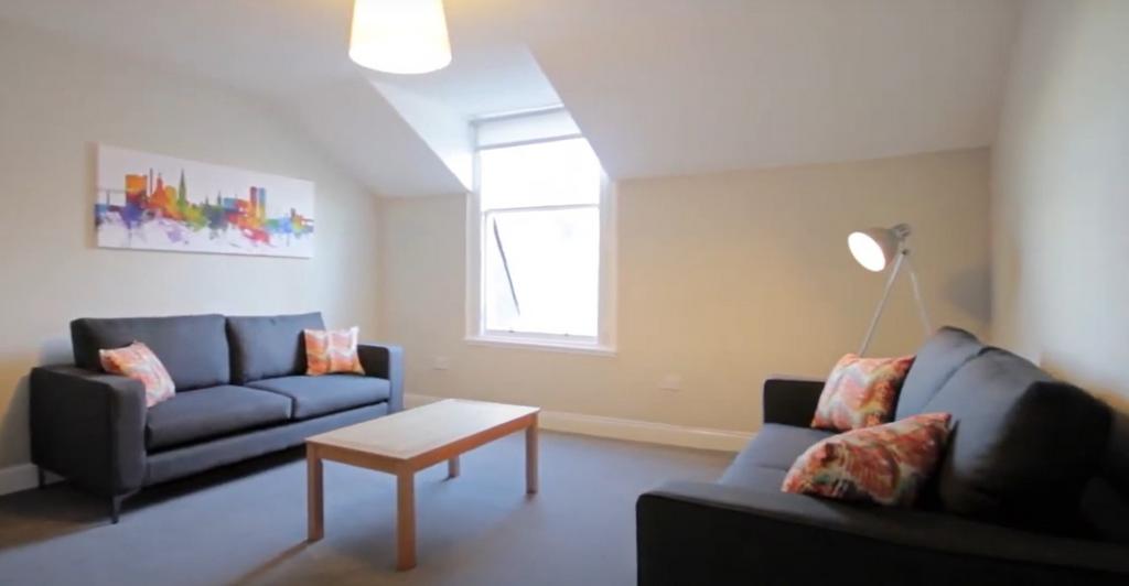 A bright and welcoming living room featuring tw...
