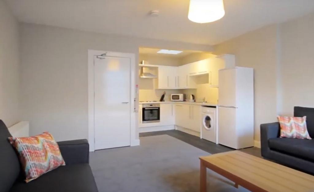 A well-maintained, modern living room featuring...