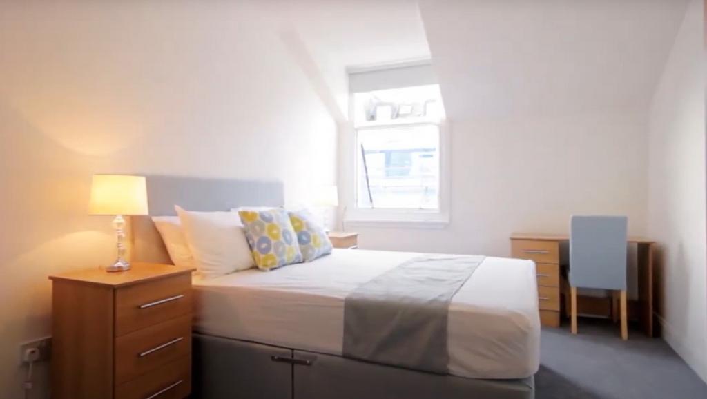 Bright and cozy double bedroom featuring a comf...