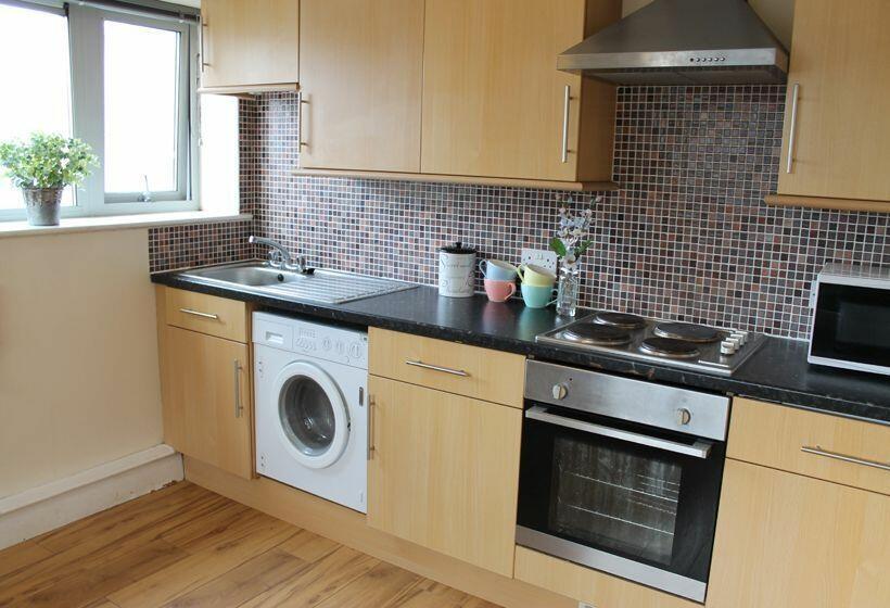 This modern kitchen features sleek wooden cabin...