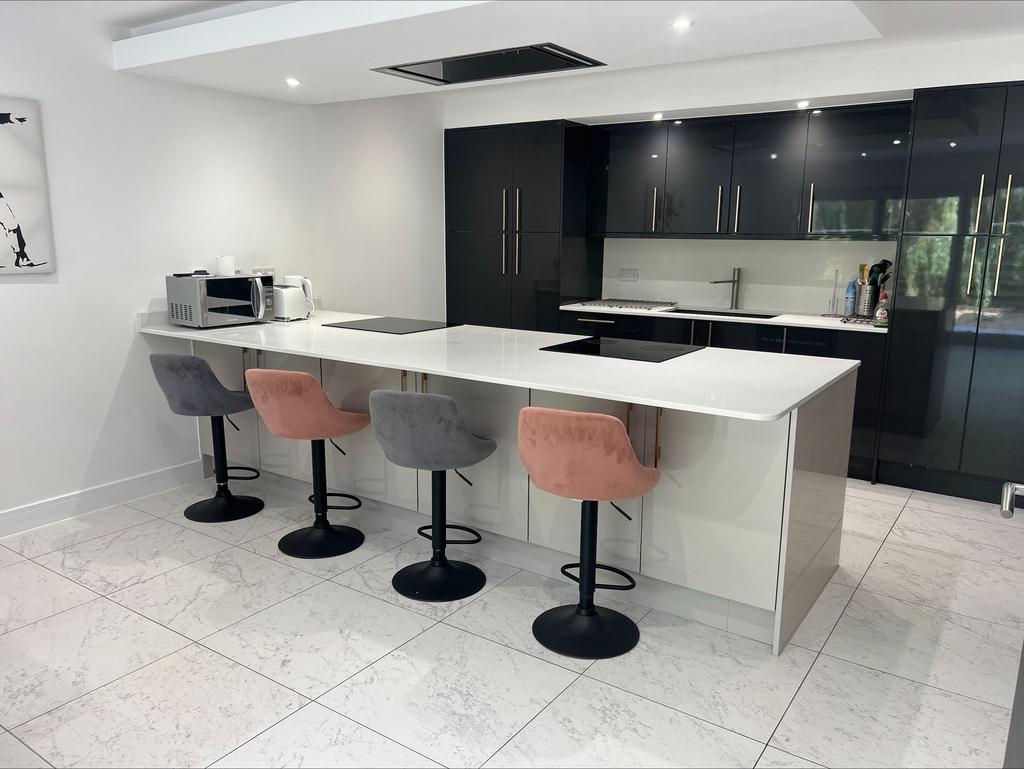 A modern kitchen featuring a sleek white island...