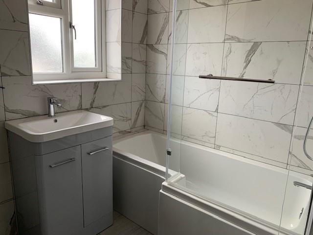 A modern and clean bathroom suite featuring a b...