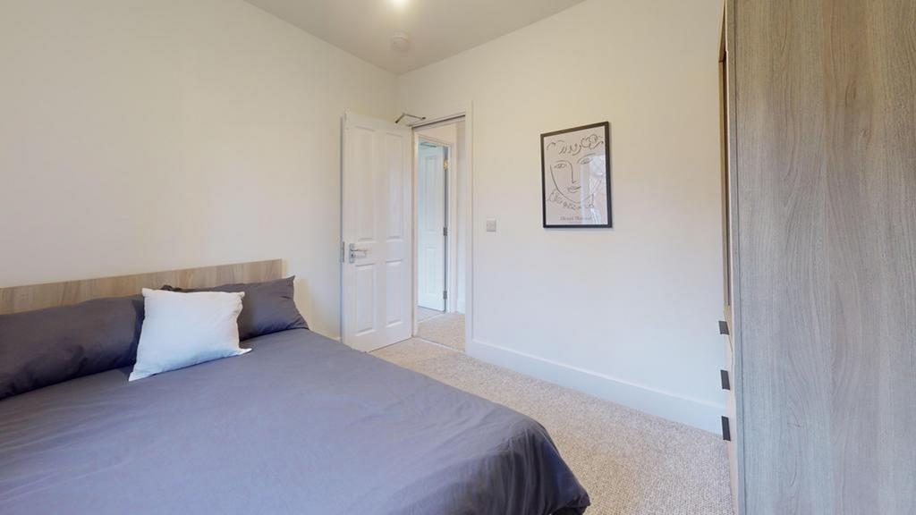A spacious and inviting double bedroom with mod...