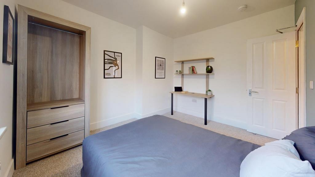 A spacious and well-lit double bedroom featurin...