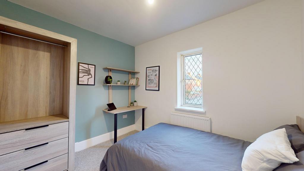A bright and inviting double bedroom featuring ...