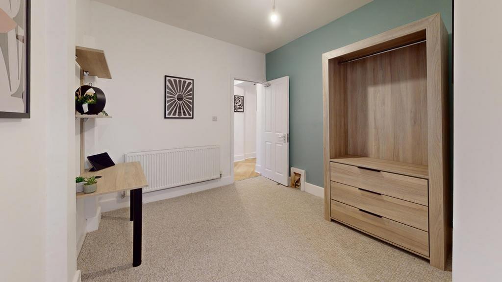A bright and tidy hallway with stylish decor, p...