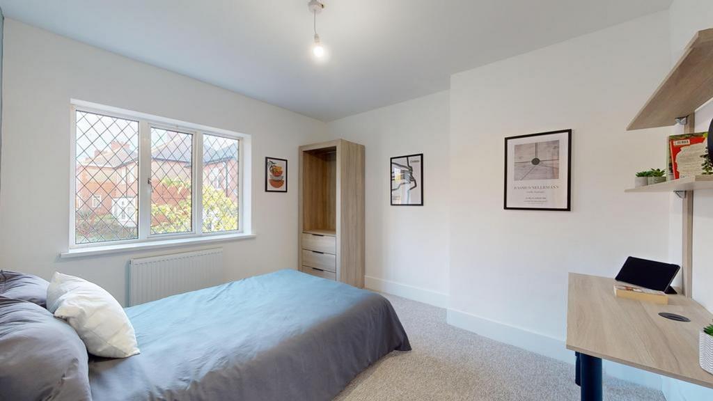 A bright and spacious double bedroom featuring ...