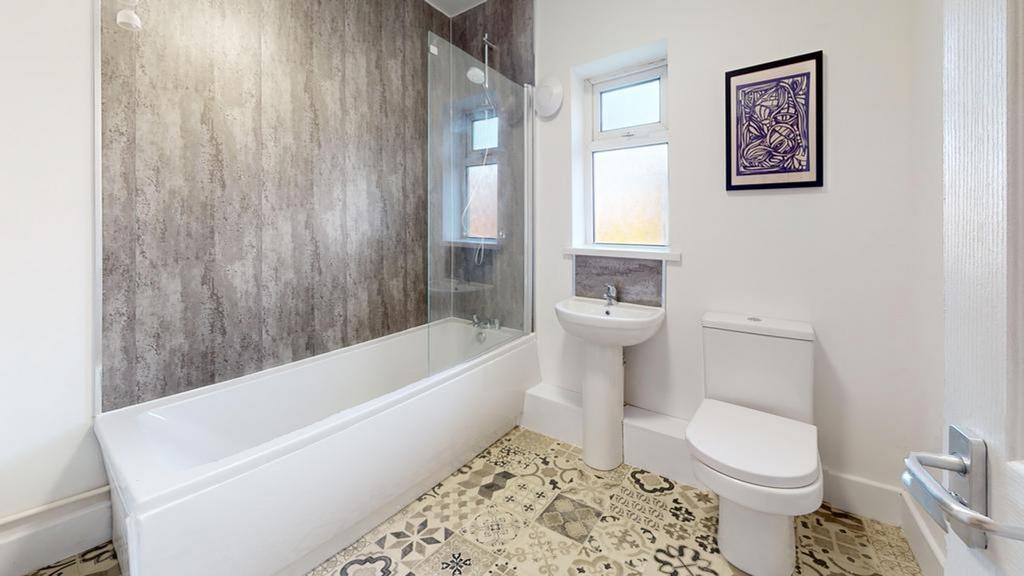 A spacious and modern bathroom featuring a styl...