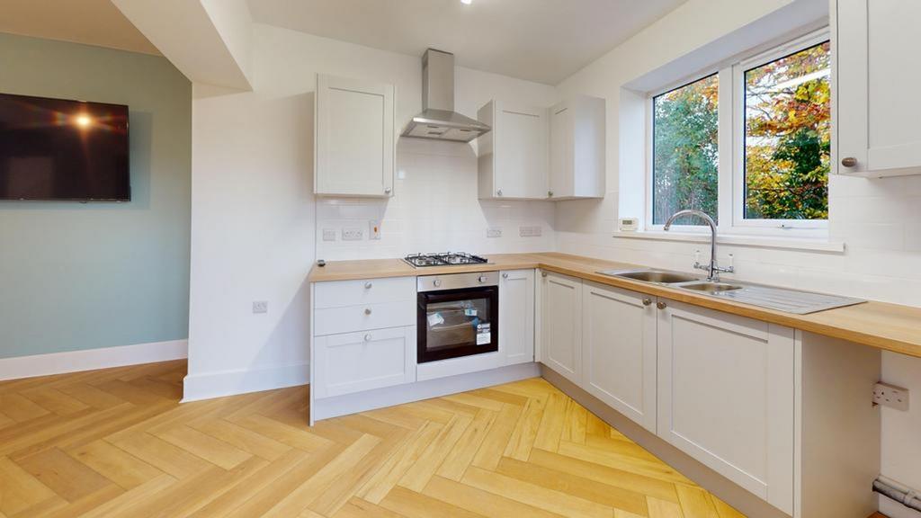 A bright and modern kitchen featuring stylish c...