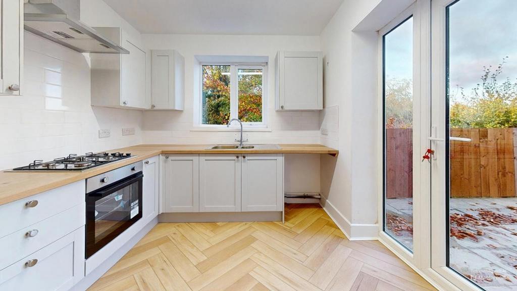 A bright and modern kitchen with ample natural ...