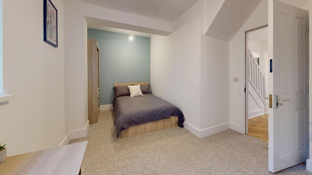 A bright and tidy double bedroom with a modern ...