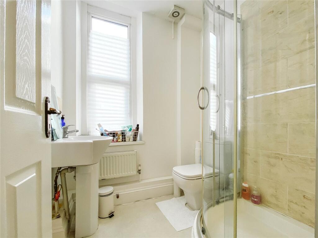 Bright and modern bathroom suite featuring a sp...