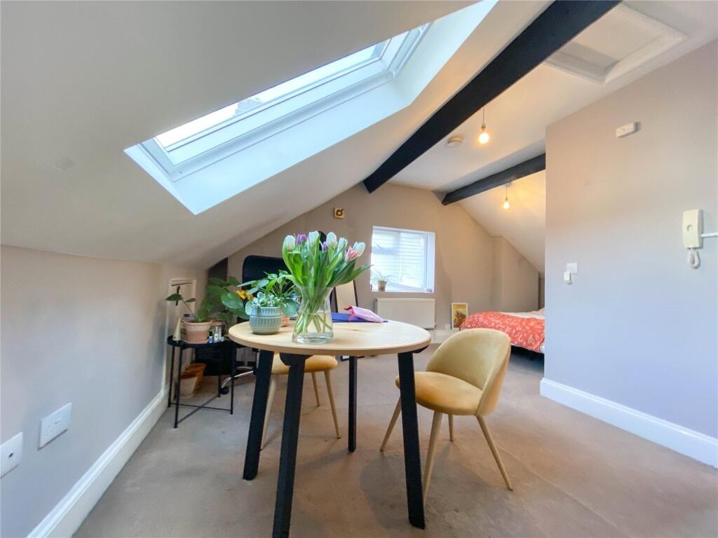 Bright and cozy double bedroom featuring a skyl...