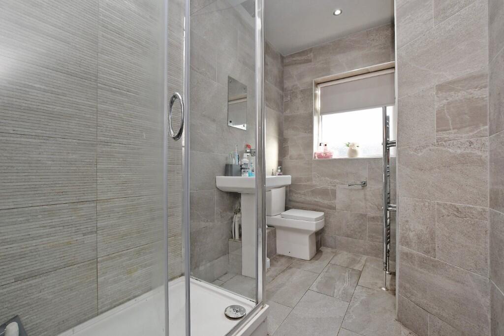 A pristine, modern bathroom featuring elegant l...