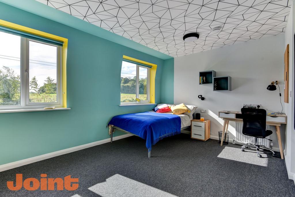 A bright and inviting double bedroom featuring ...