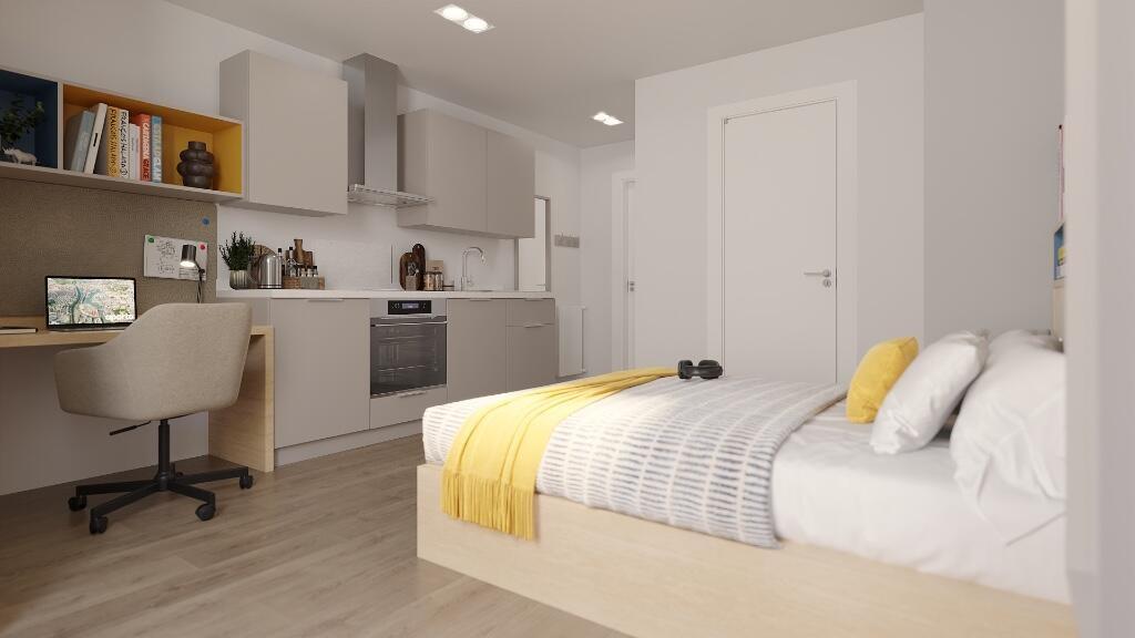 A modern and bright studio bedroom featuring a ...