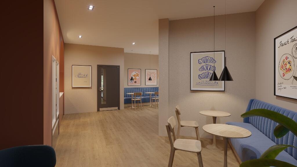 A modern communal lounge with warm lighting, co...