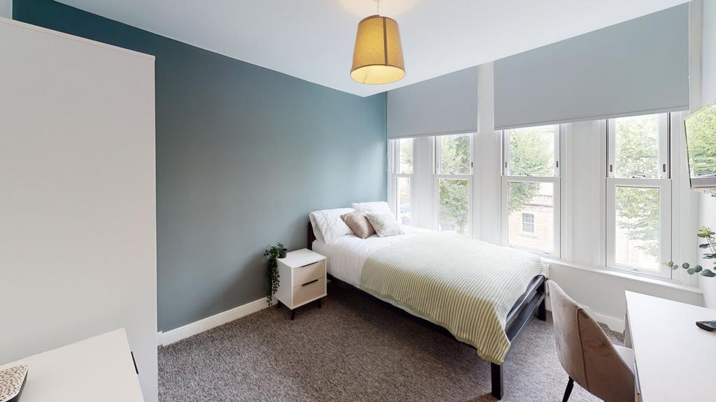 A bright and inviting double bedroom with large...
