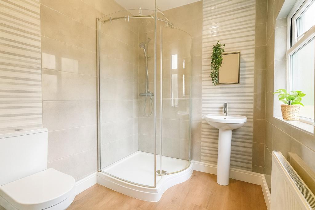Bright and inviting modern bathroom featuring a...