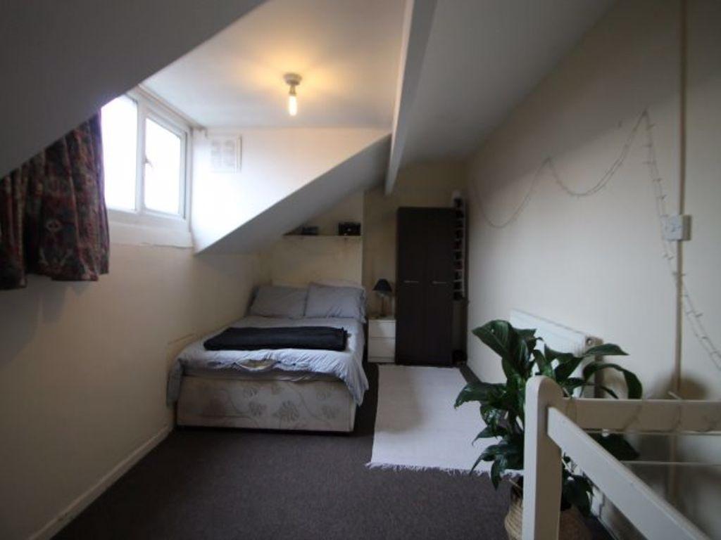 A cozy master bedroom with a double bed positio...