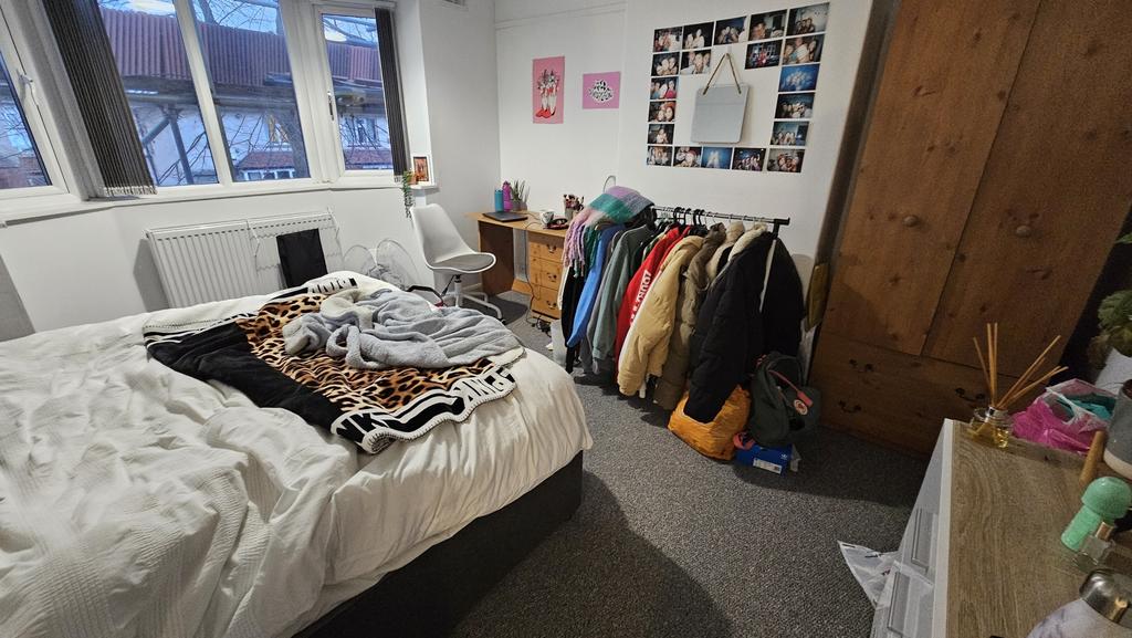 A cozy double bedroom with a comfortable bed, a...