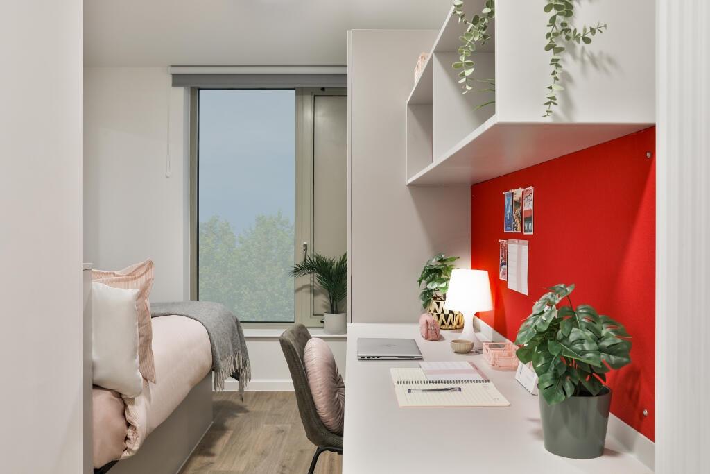 Bright and modern single bedroom featuring a co...