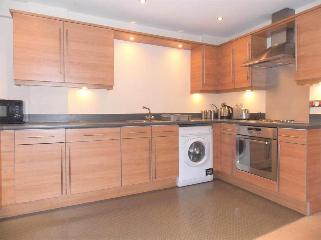 Modern kitchen with ample wooden cabinetry, int...