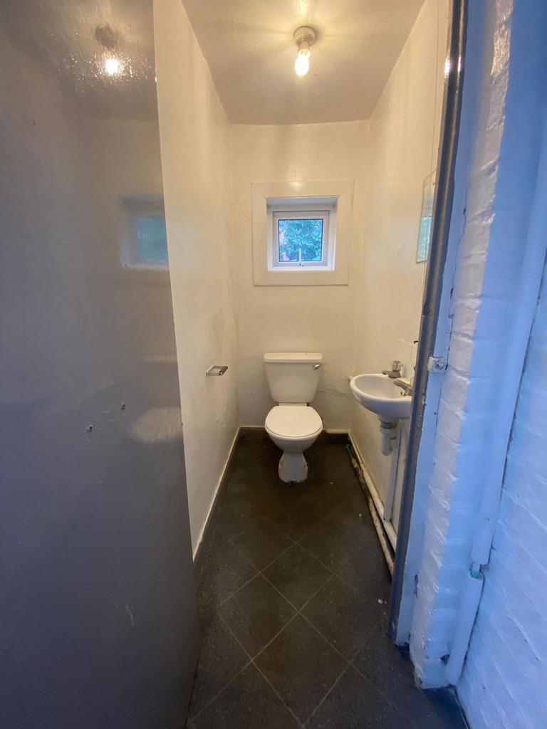 A compact and functional single toilet room fea...