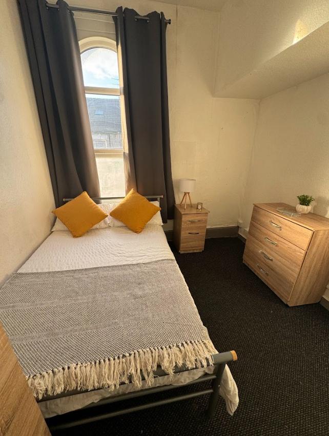 Cozy single bedroom featuring a comfortable bed...