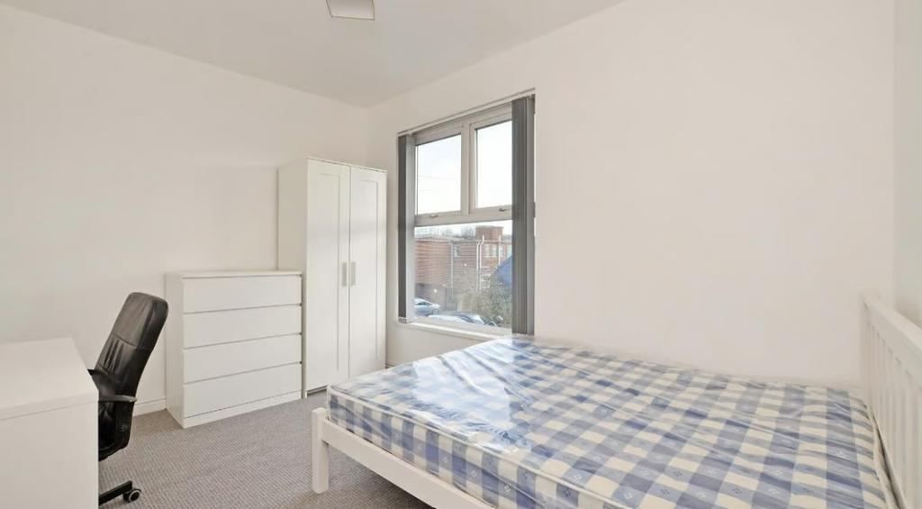 A bright and inviting double bedroom featuring ...