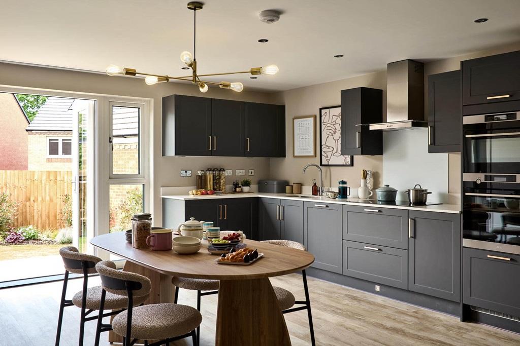 An open plan kitchen and dining area, with...