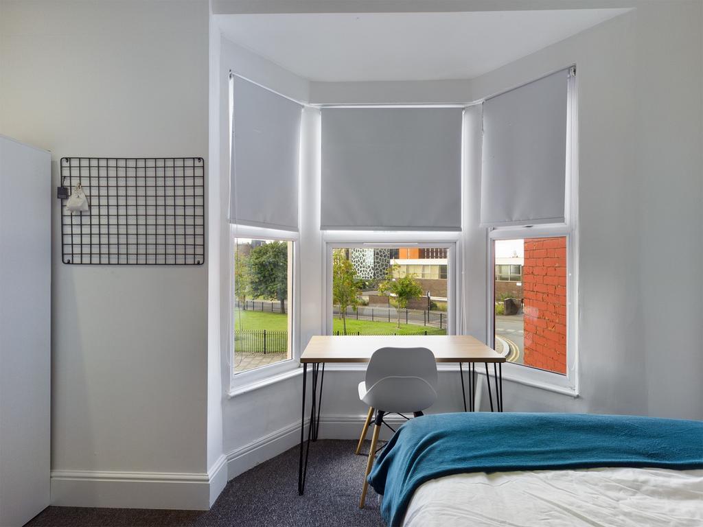 A bright and inviting double bedroom featuring ...