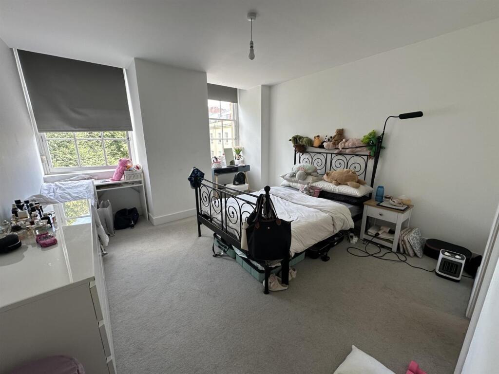 A bright and airy master bedroom featuring a la...