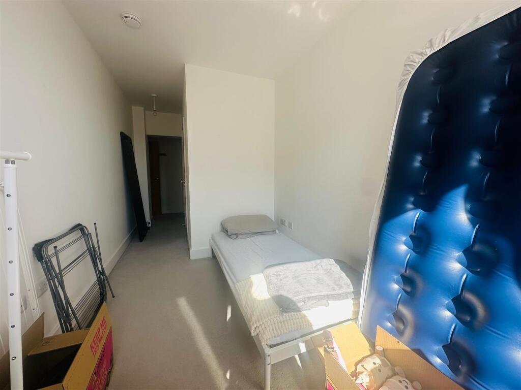 A bright and simple narrow room featuring a sin...