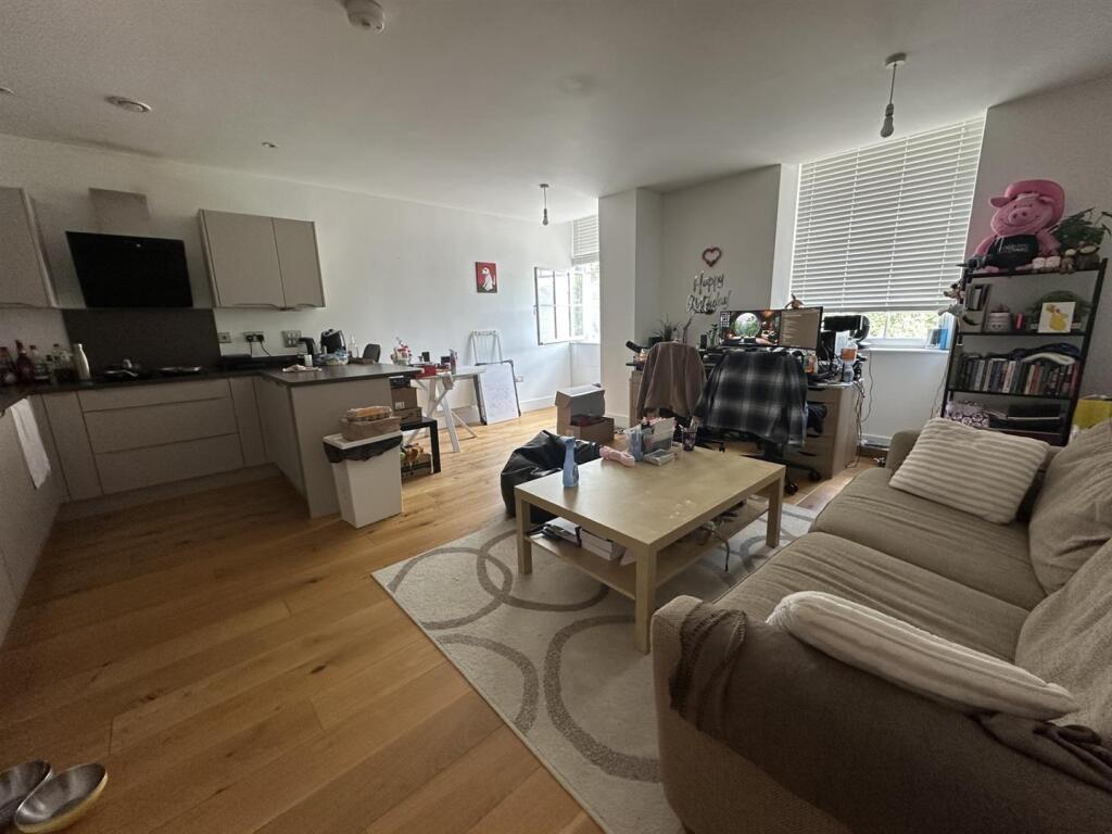 A cozy and well-furnished living room featuring...