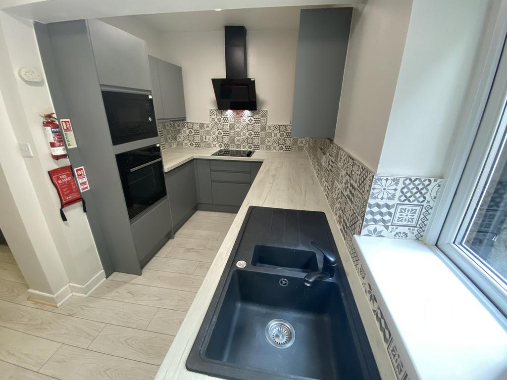 Modern kitchen featuring sleek cabinetry and st...