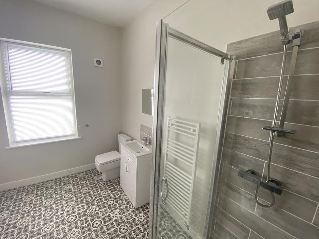 A bright and modern bathroom featuring a spacio...