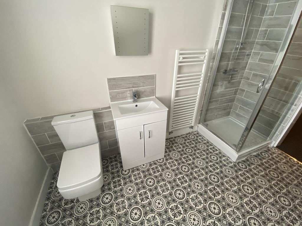 A modern bathroom featuring a stylish shower, s...