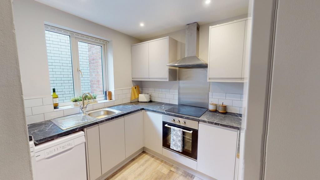 A modern and well-lit kitchenette featuring sle...