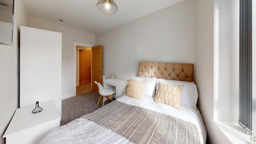 A stylish and inviting double bedroom with ampl...