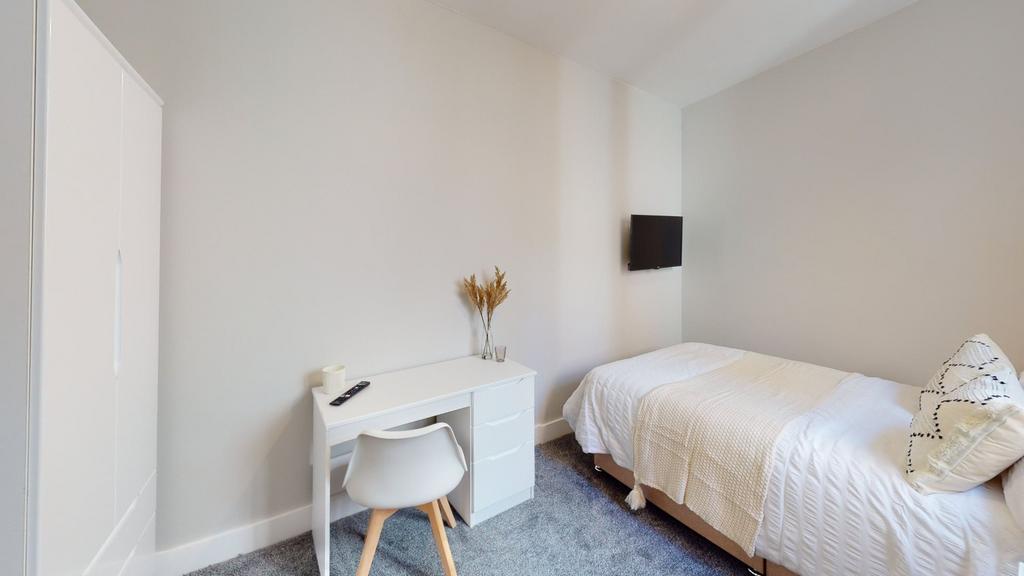 A bright and inviting double bedroom featuring ...